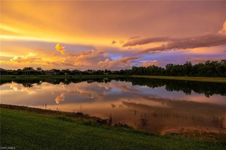 Waterfront property with expansive serene water reflections at sunset