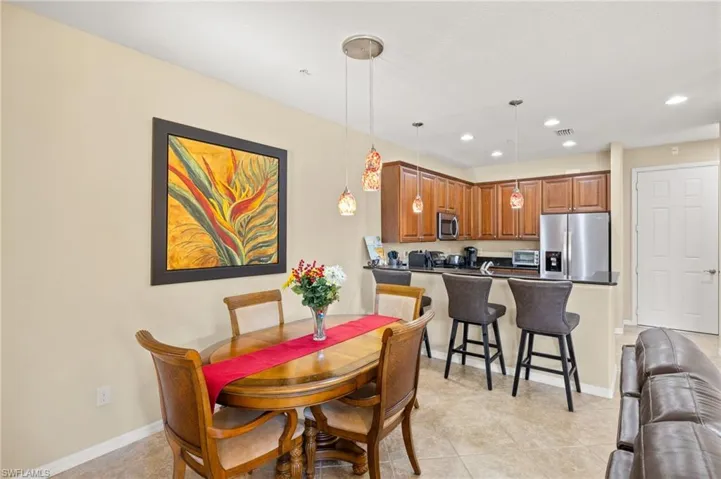 Dining area with recessed lighting, light tile patterned floors, and baseboards