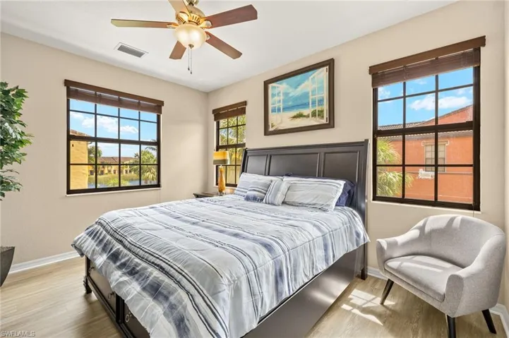 Bedroom with baseboards, wood finished floors, and ceiling fan