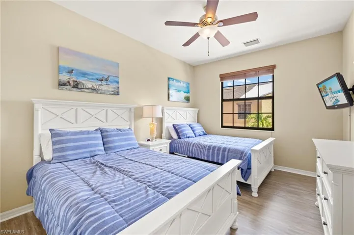 Bedroom with baseboards, light wood-style floors, and ceiling fan
