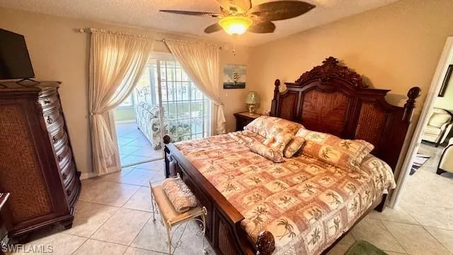 Bedroom with water view and sliding doors to sunroom