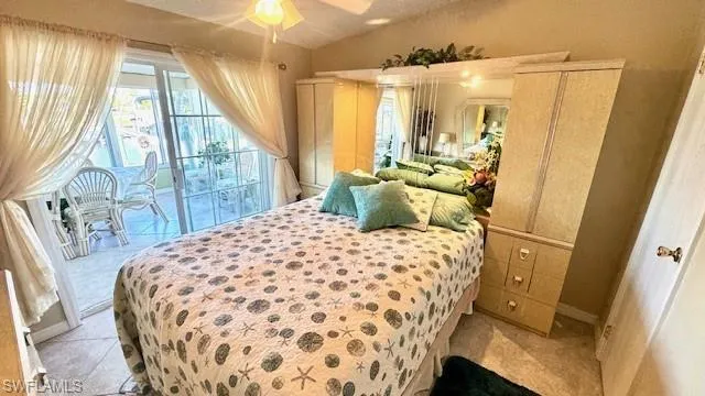 2nd bedroom with water view and sliding doors to the sunroom