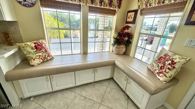 sitting area in kitchen looking out to pond in front of home.  Storage underneath