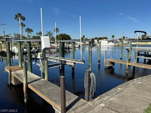 Dock area featuring boat lift and a water view