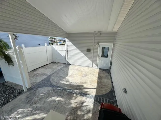Carport and entrance into sunroom