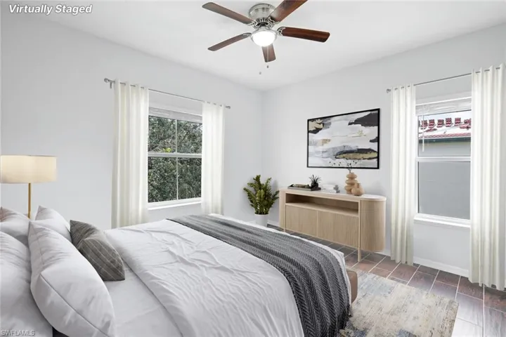 Bedroom with ceiling fan and dark hardwood / wood-style floors