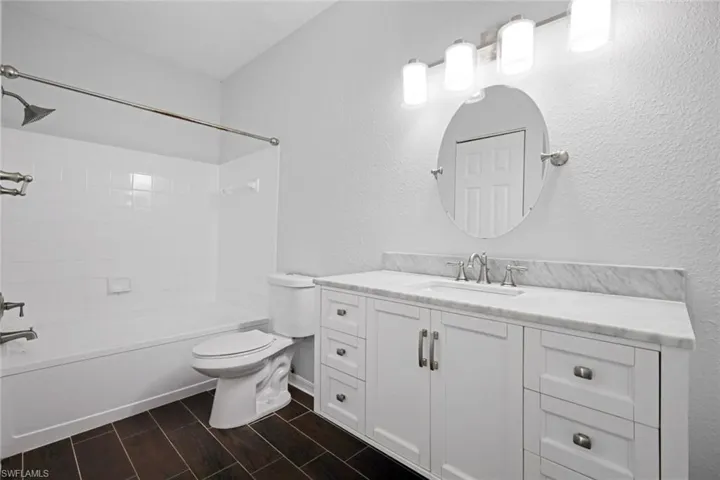 Full bathroom with vanity, toilet, and shower / washtub combination