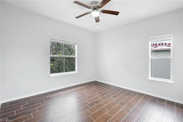 Spare room featuring dark hardwood / wood-style floors and ceiling fan