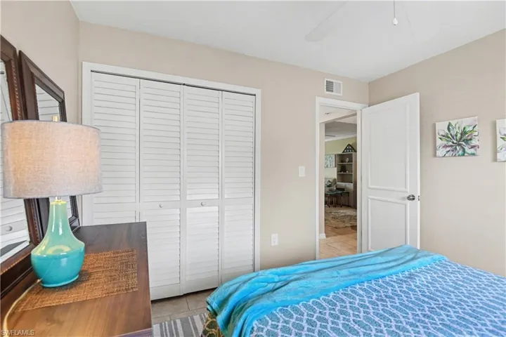 Bedroom with a ceiling fan, a closet, and light tile patterned flooring