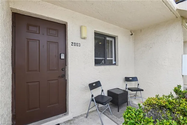 Entrance to property featuring stucco siding