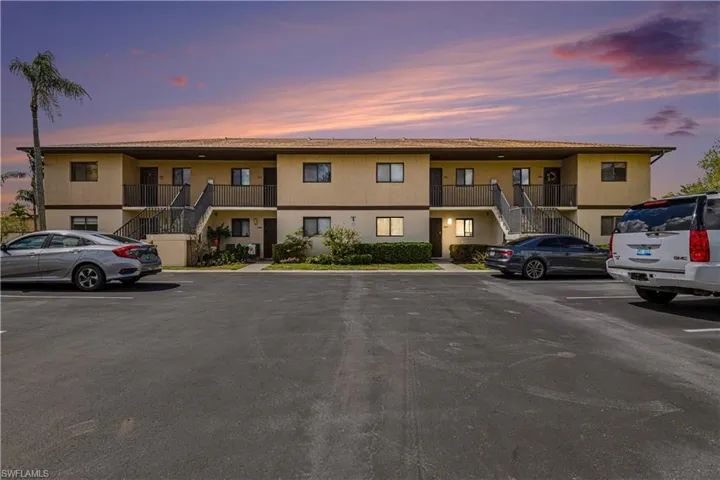 View of property with uncovered parking