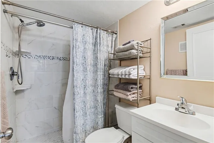 Bathroom featuring vanity and a stall shower
