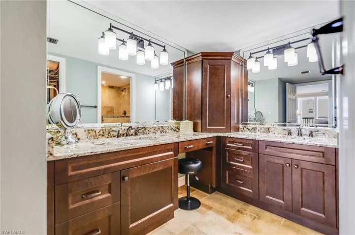 Bathroom with vanity and tiled shower