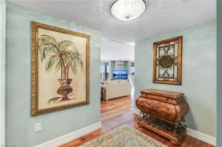 Hall featuring wood finished floors and baseboards