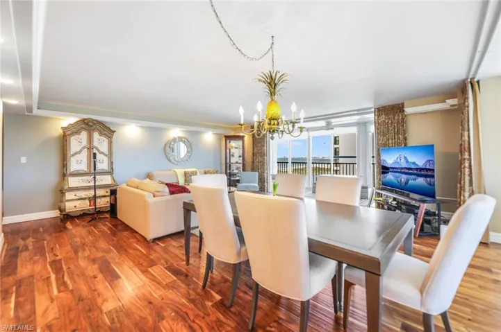 Dining room featuring wood finished floors and suspended lighting