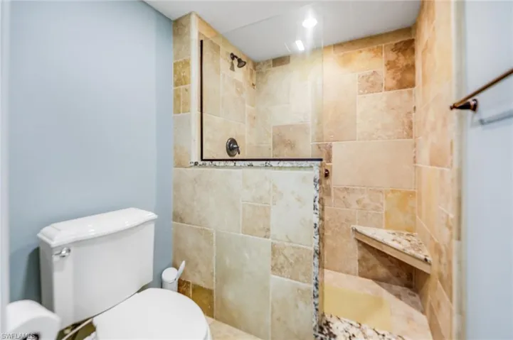 Bathroom with walk in shower and recessed lighting