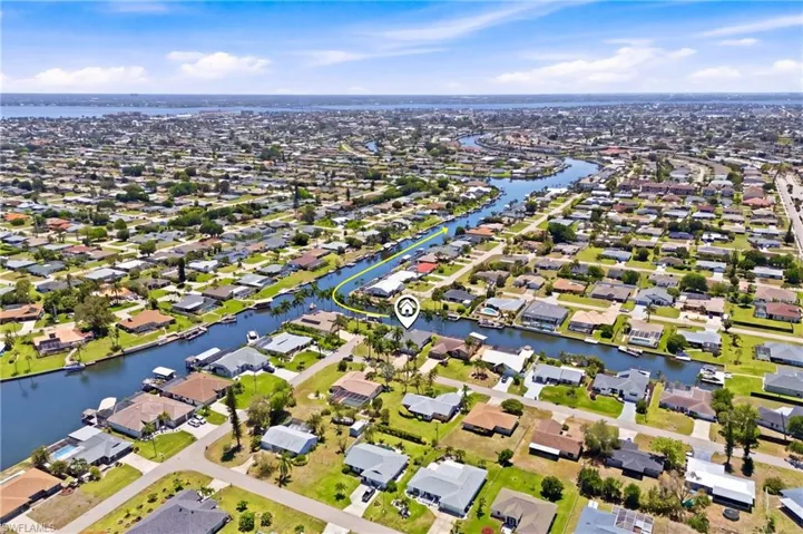 Aerial view showcasing the property's waterfront location, surrounded by canals and residential properties