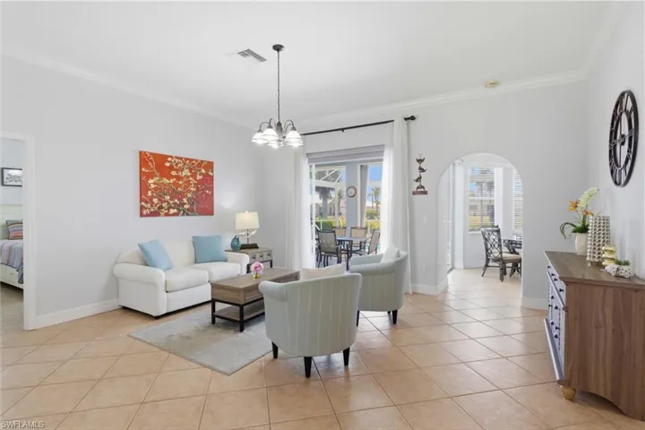 The property features tile flooring, crown molding, and a light fixture