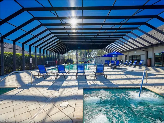 Community pool featuring a patio area and glass enclosure