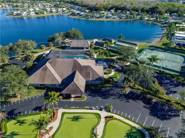 Aerial overview of property's location featuring a nearby body of water and nearby suburban area