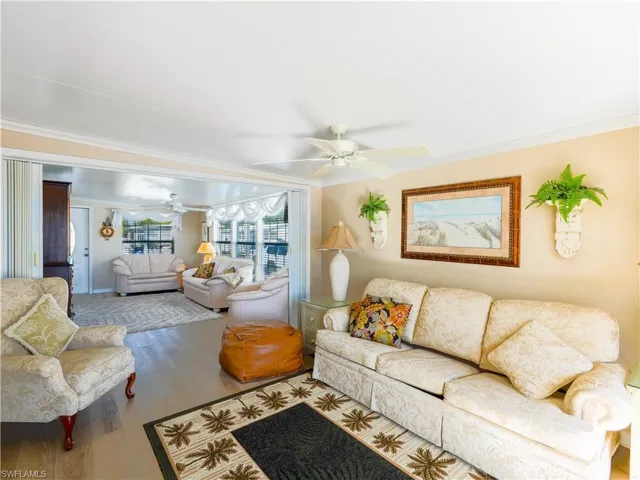 Living room featuring ornamental molding and hardwood / wood-style floors