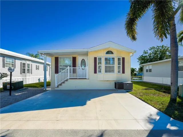 Manufactured / mobile home with a patio area, covered porch, and a front yard