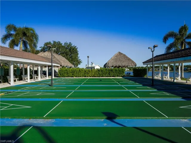 View of tennis court with shuffleboard and community basketball court