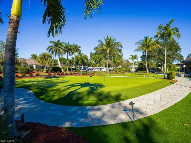 View of property's community with an area to practice putting and a yard