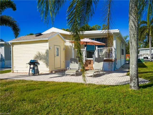 Rear view of property with a patio area, a lawn, and a deck