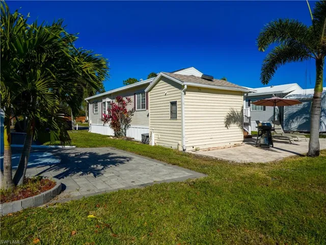 View of home's exterior featuring a patio area and a yard
