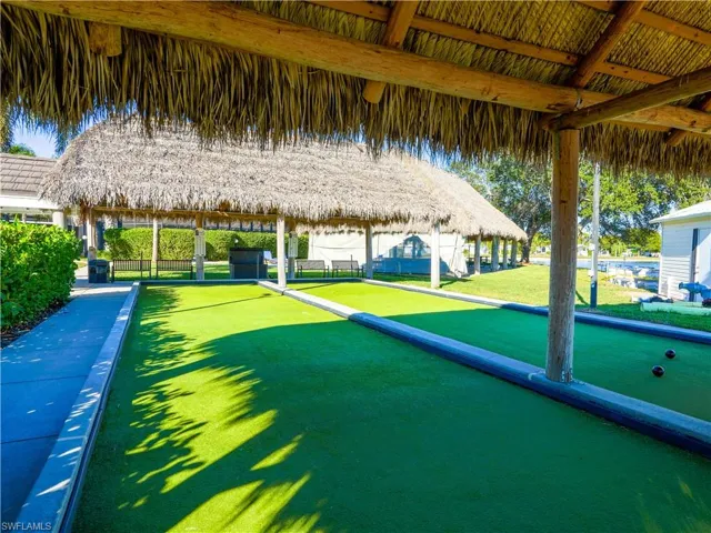 View of home's community featuring a lawn and a game area