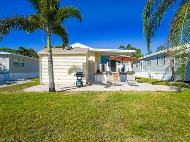 Rear view of house featuring a patio and a yard