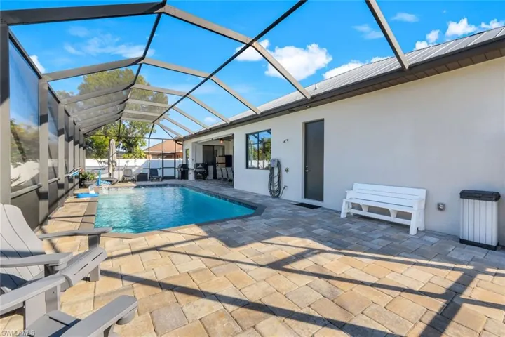 View of pool, lanai and outdoor shower