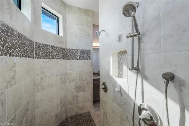 Bathroom with open dual-head shower and dual vanity