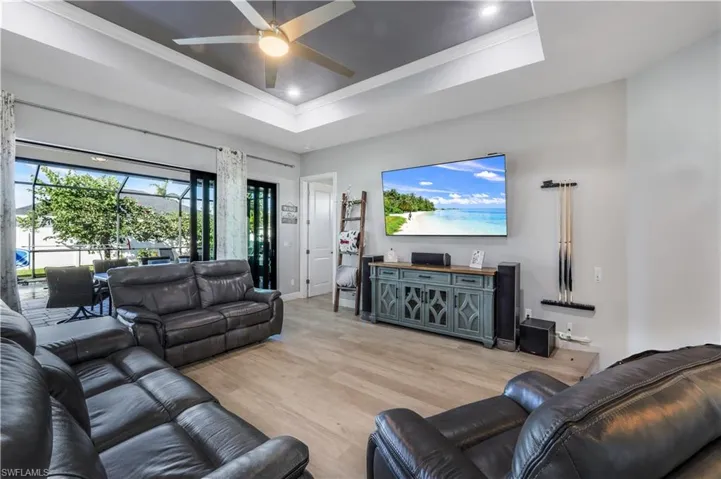 Great room with tray ceiling, opens to lanai