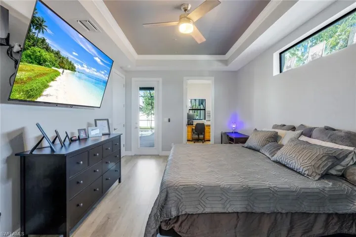 Bedroom maximizes natural light with transom window, adjacent office or nursery space, and access to lanai.