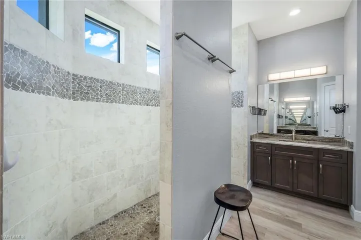 Bathroom with open dual-head shower and dual vanity