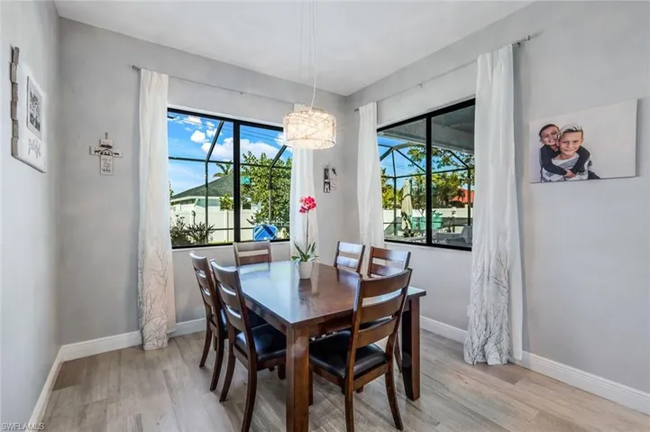 Dining area with lots of light and an inviting chandelier