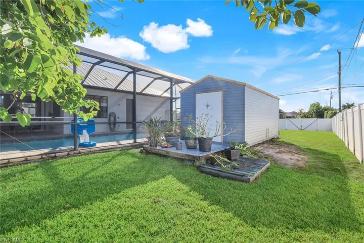 Back of property with shed and fence