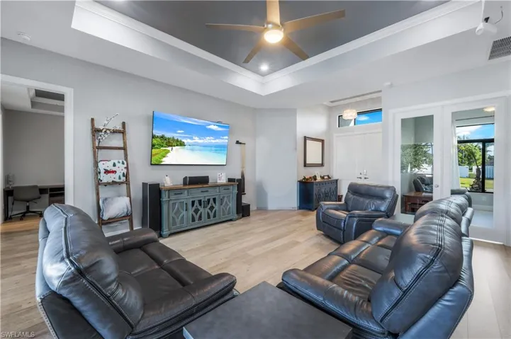 Great room with tray ceiling, French doors open to 4th bedroom/flex room.