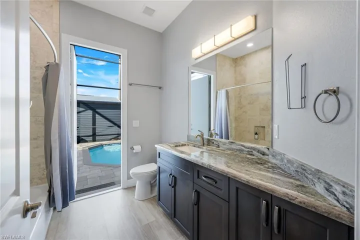 Bathroom with access to pool area