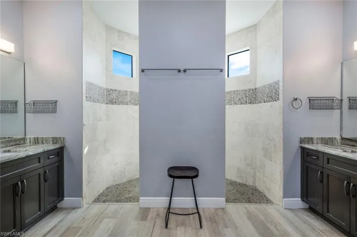 Bathroom with open dual-head shower and dual vanity