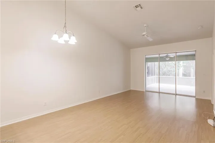 Spacious living area with vaulted ceiling.