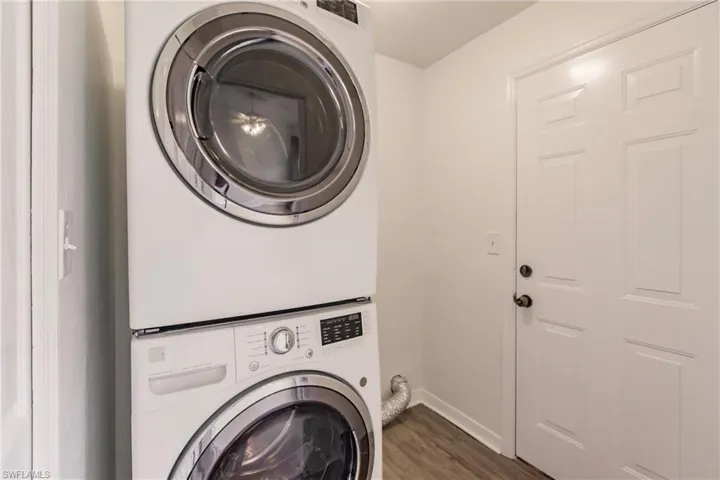 Laundry area with stacked, front load washing maching and dryer.