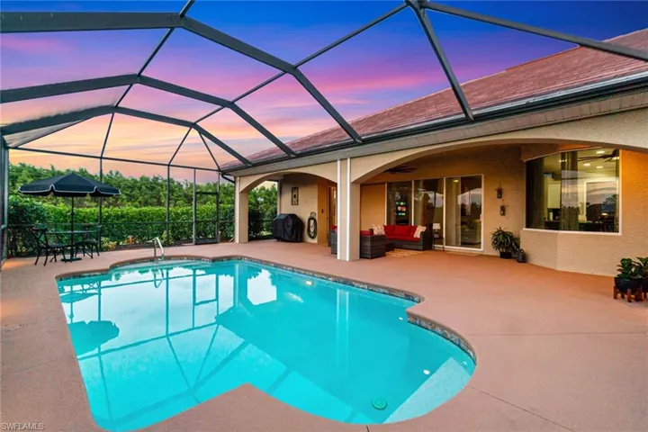 Heated saltwater pool with pocket sliders and half bath accessible from lanai area