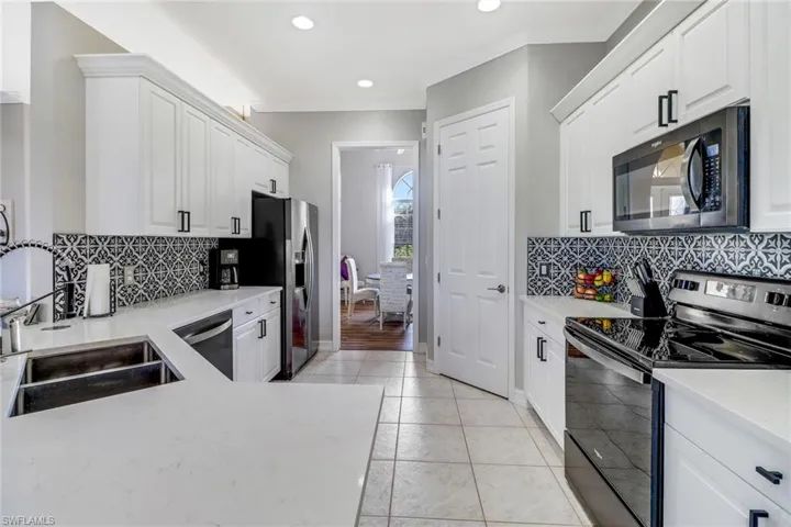 Quartz countertops, large pantry and newer stainless appliances; pocket door can be cloed between kitchen and formal dining room