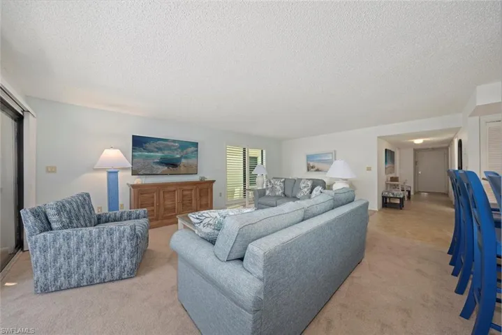 Living room with carpet and a textured ceiling