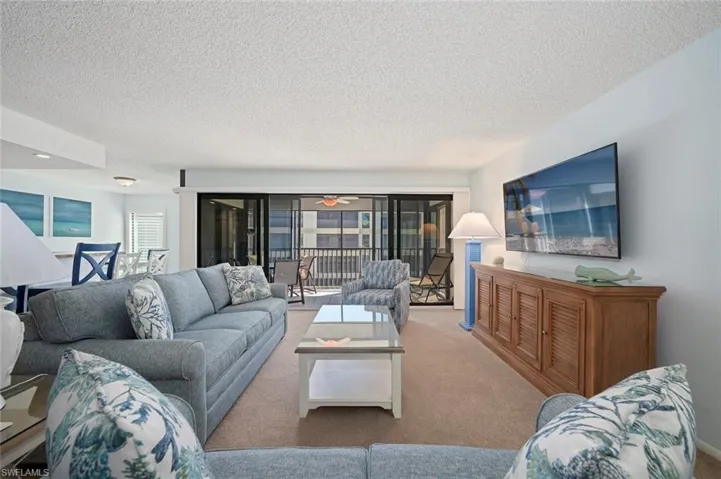Carpeted living area with a textured ceiling
