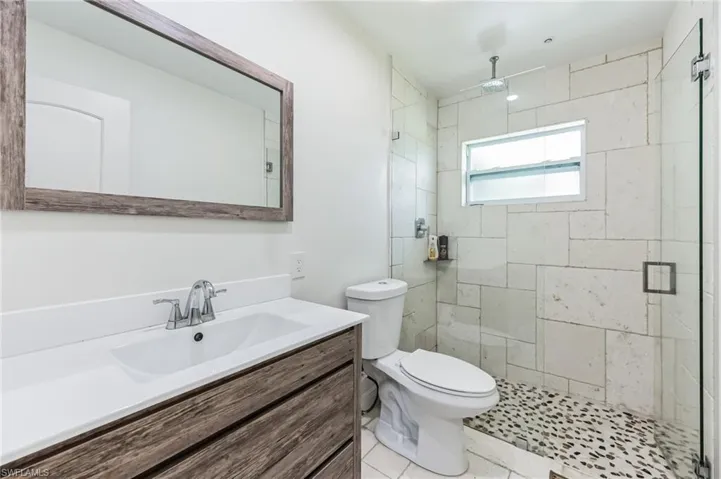 FULL Hallway Bathroom with an enclosed shower, tile floors, and large vanity