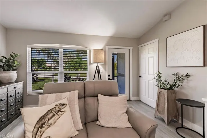 Living room with light wood finished floors and baseboards